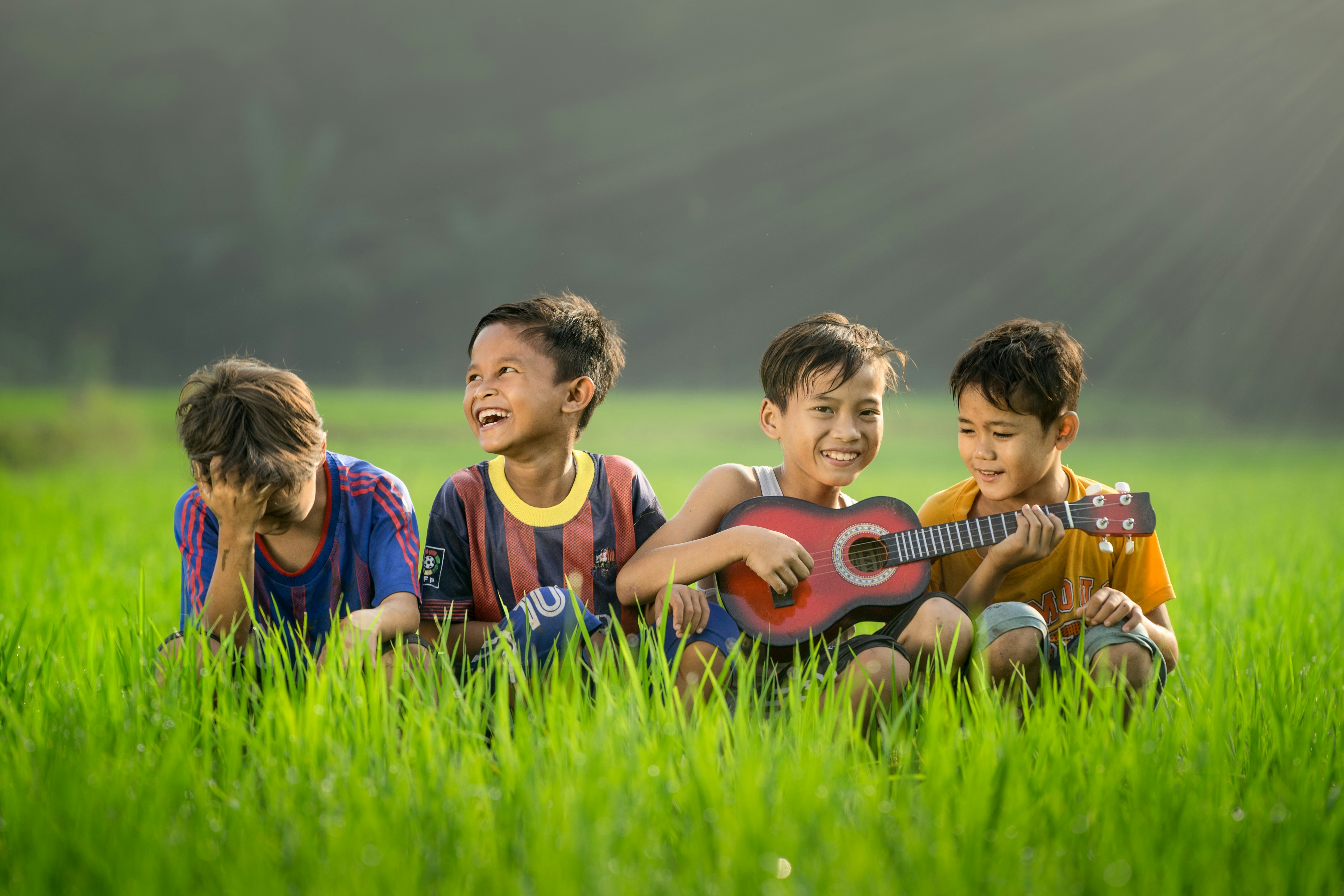 Children playing together with guitar